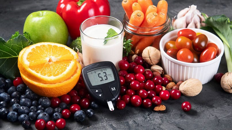 Fresh fruits, vegetables, and a blood glucose meter representing healthy eating and diabetes management from Boedirep.